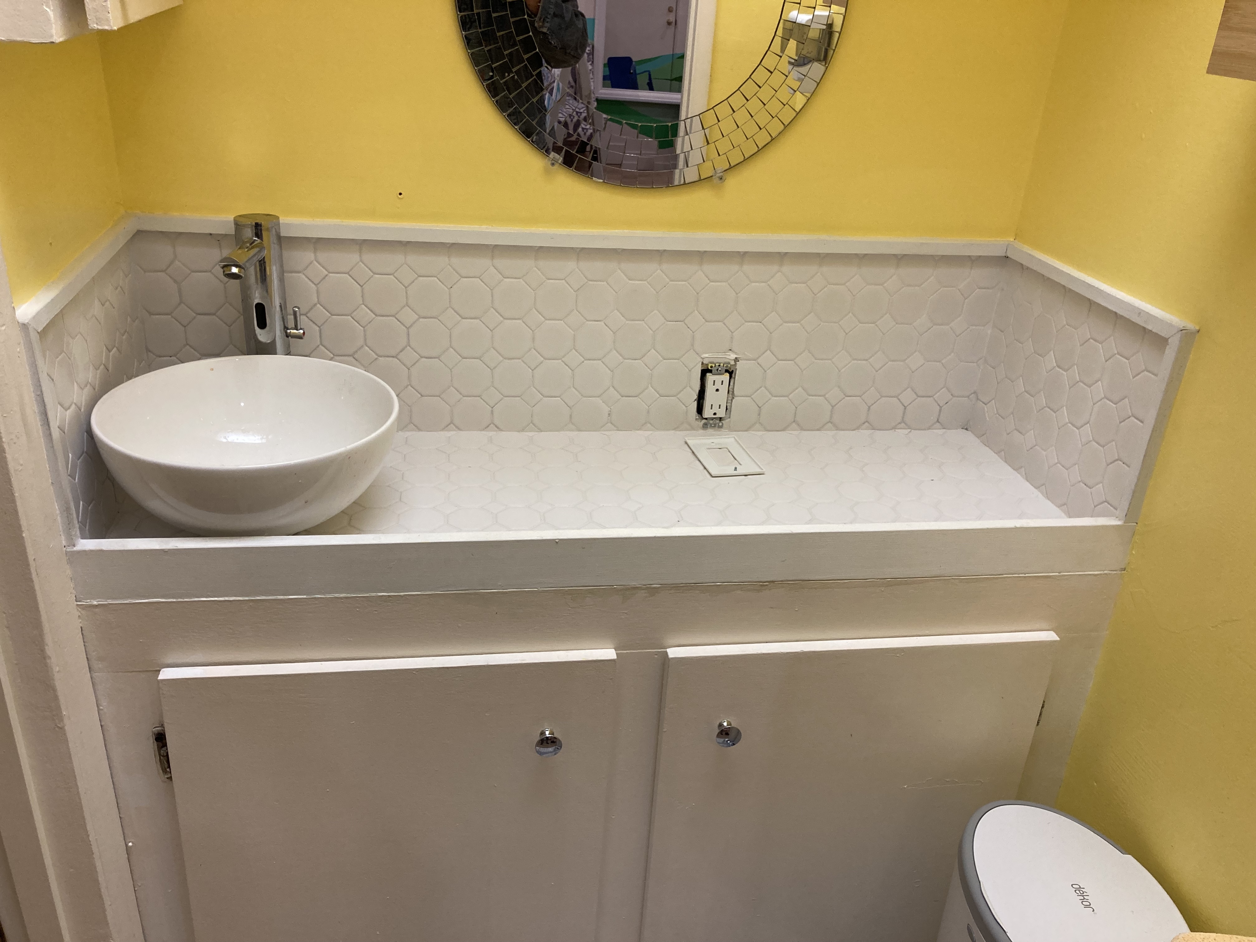 Bathroom sink with tile and wood trim custom built-in