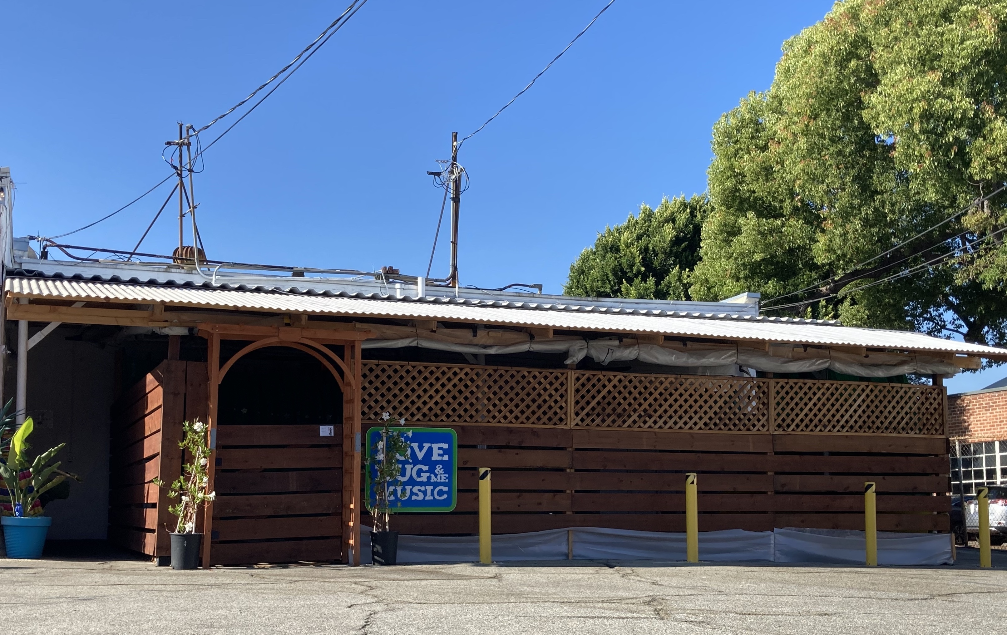 Outdoor patio with corrugated roof in South Pasadena, custom pergola structure